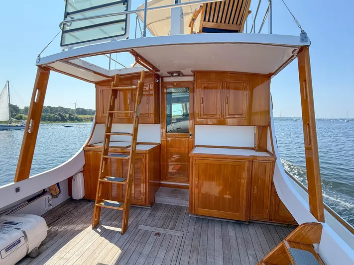 Argonaut Yacht Photos Pics Wooden interior of 1984 Wilbur 38 boat with ladder, cabinets, and ocean view.