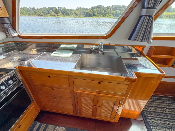 Argonaut Yacht Photos Pics Interior of 1984 Wilbur 38 boat with wooden cabinetry and stainless steel sink.