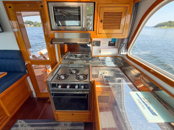 Argonaut Yacht Photos Pics Interior of 1984 Wilbur 38 boat with kitchen, stove, and scenic water view.