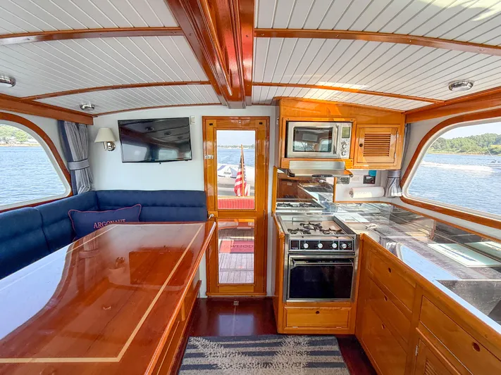 Argonaut Yacht Photos Pics Interior of 1984 Wilbur 38 yacht with kitchen, dining area, and scenic water view.