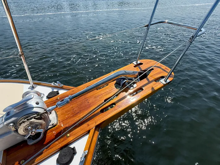 Argonaut Yacht Photos Pics Bow of 1984 Wilbur 38 boat with anchor and wooden deck over water.