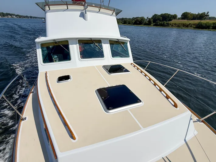 Argonaut Yacht Photos Pics 1984 Wilbur 38 boat cruising on a calm river under clear skies.