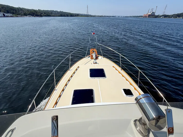 Argonaut Yacht Photos Pics 1984 Wilbur 38 boat cruising on a calm river with scenic shoreline views.