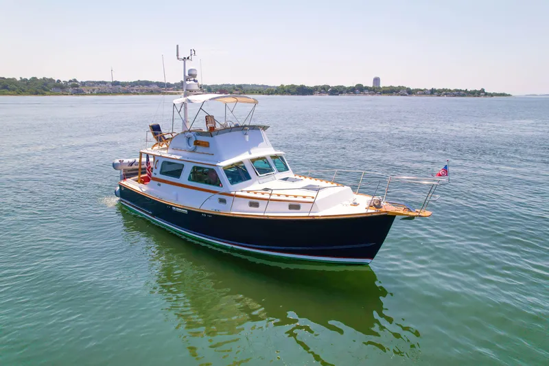 Argonaut Yacht Photos Pics Classic 1984 Wilbur 38 boat on calm water, showcasing elegant design and craftsmanship.