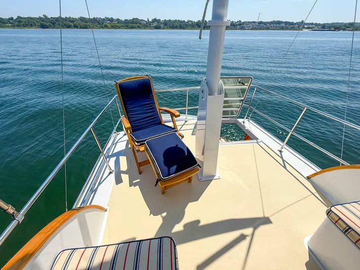 Argonaut Yacht Photos Pics Sunny deck of 1984 Wilbur 38 yacht with lounge chairs overlooking calm waters.