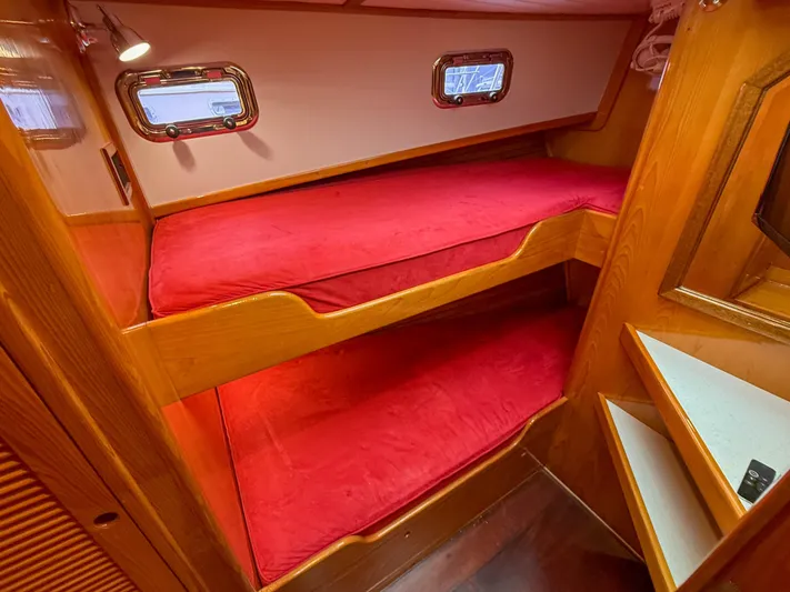Argonaut Yacht Photos Pics Cozy cabin with red bunk beds in a 1984 Wilbur 38 boat.