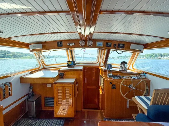 Argonaut Yacht Photos Pics Interior of a 1984 Wilbur 38 boat with wooden finishes and navigational equipment.