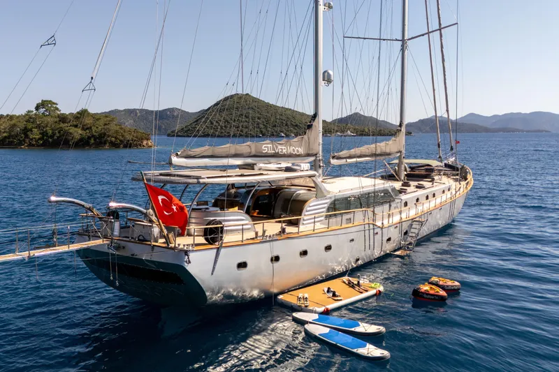 Silvermoon Yacht Photos Pics Custom 2010 Gulet Motorsailer anchored in scenic bay with paddleboards and inflatables.