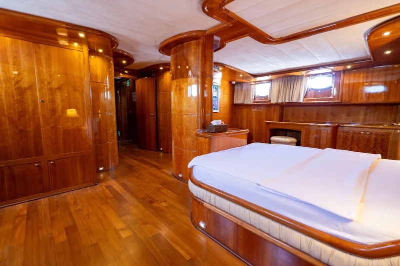 Silvermoon Yacht Photos Pics Luxurious wooden interior of 2010 Custom Gulet Motorsailer cabin with bed and portholes.