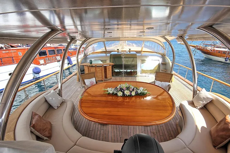 Silvermoon Yacht Photos Pics Luxurious 2010 Custom Gulet Motorsailer deck with elegant seating and wooden table.