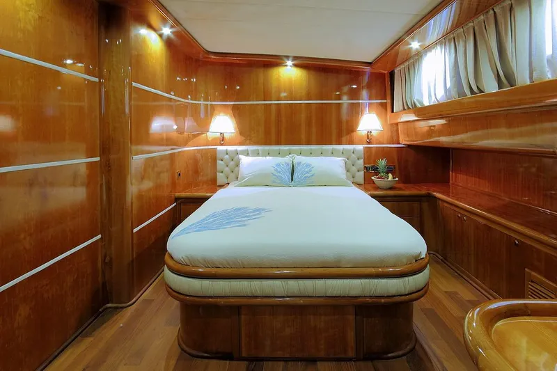 Silvermoon Yacht Photos Pics Luxurious cabin interior of 2010 Custom Gulet Motorsailer with polished wood and elegant bedding.