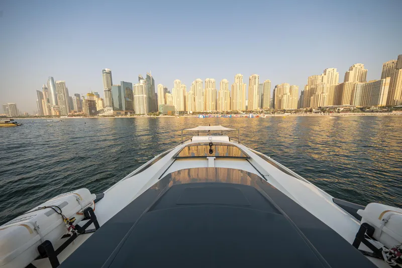 Yacht Photos Pics Numarine 105HT yacht cruising towards a city skyline, 2016 model.