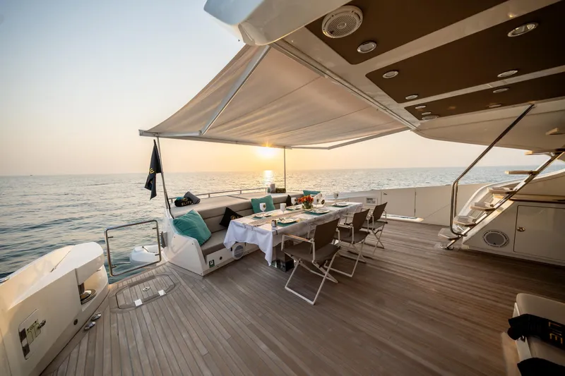  Yacht Photos Pics Luxurious 2016 Numarine 105HT yacht deck with dining setup at sunset.