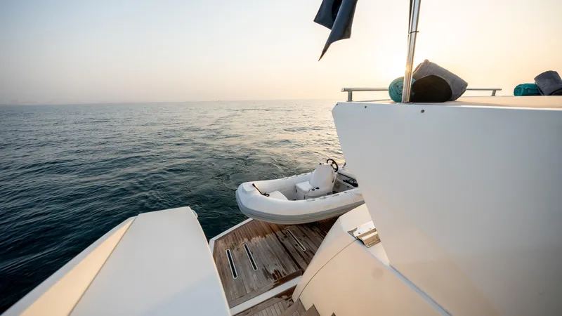  Yacht Photos Pics Luxury Numarine 105HT yacht deck with tender, 2016 model, at sea during sunset.