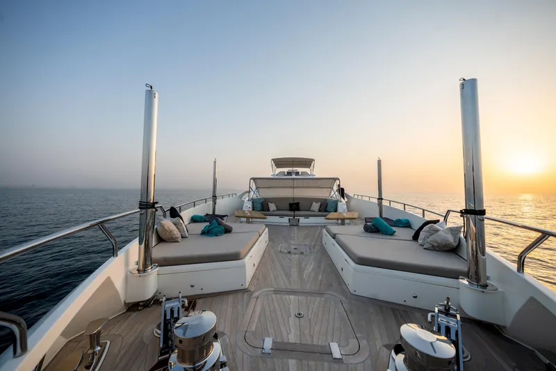  Yacht Photos Pics Luxurious 2016 Numarine 105HT yacht deck at sunset, featuring elegant seating and ocean views.