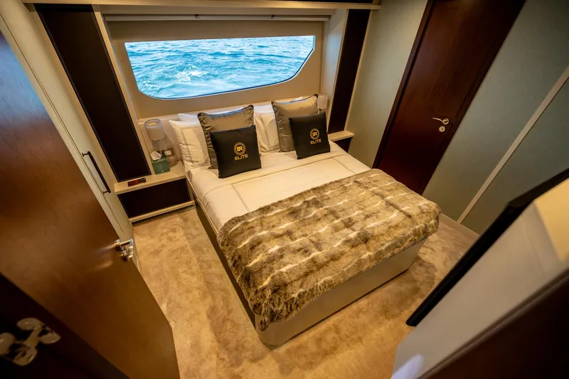  Yacht Photos Pics Luxurious bedroom interior of 2016 Numarine 105HT yacht with ocean view window.