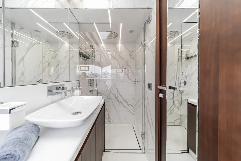  Yacht Photos Pics Luxurious bathroom in 2023 Galeon 640 Fly yacht with marble walls and modern fixtures.