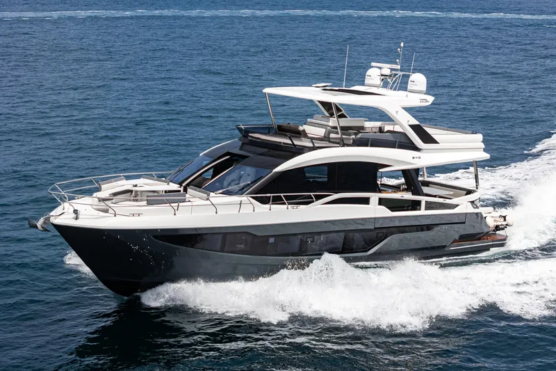  Yacht Photos Pics 2023 Galeon 640 Fly yacht cruising on open water, showcasing sleek design and luxury features.