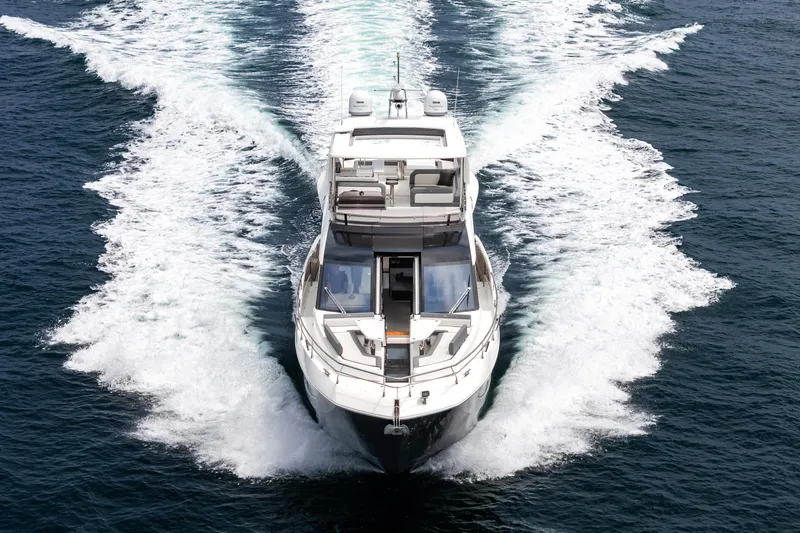  Yacht Photos Pics 2023 Galeon 640 Fly yacht cruising on open water, aerial view.