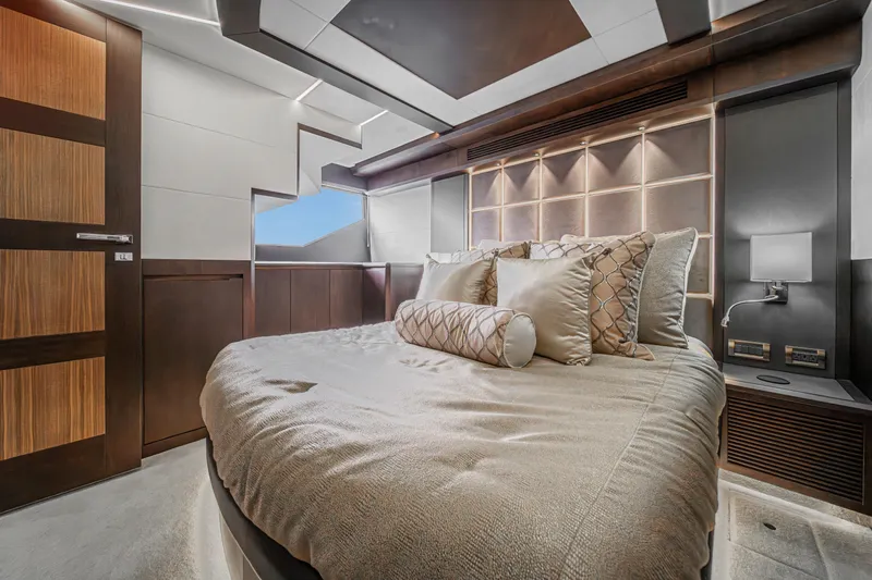  Yacht Photos Pics Luxurious bedroom interior of 2023 Galeon 640 Fly yacht with elegant bedding and modern design.