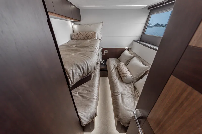  Yacht Photos Pics Luxurious cabin interior of 2023 Galeon 640 Fly yacht with cozy bedding and window view.