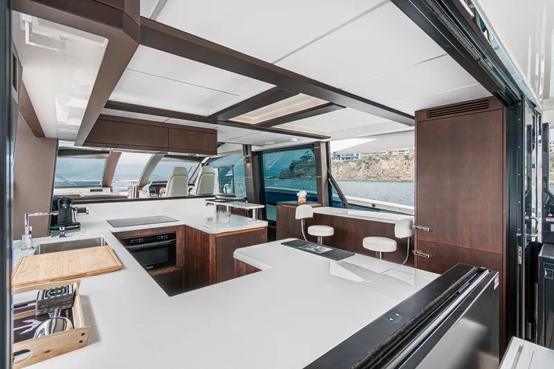  Yacht Photos Pics Luxurious interior of 2023 Galeon 640 Fly yacht with modern kitchen and ocean view.