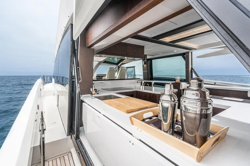  Yacht Photos Pics 2023 Galeon 640 Fly yacht with sleek outdoor bar and ocean view.
