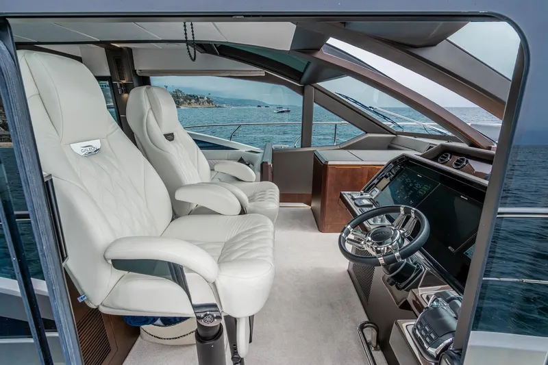  Yacht Photos Pics Luxurious interior of 2023 Galeon 640 Fly yacht with modern helm and plush seating.