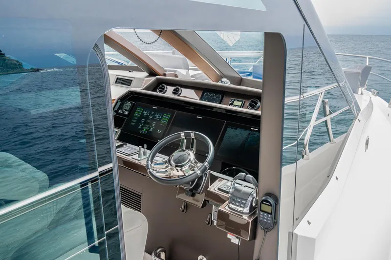  Yacht Photos Pics 2023 Galeon 640 Fly yacht helm with advanced navigation systems on open sea.