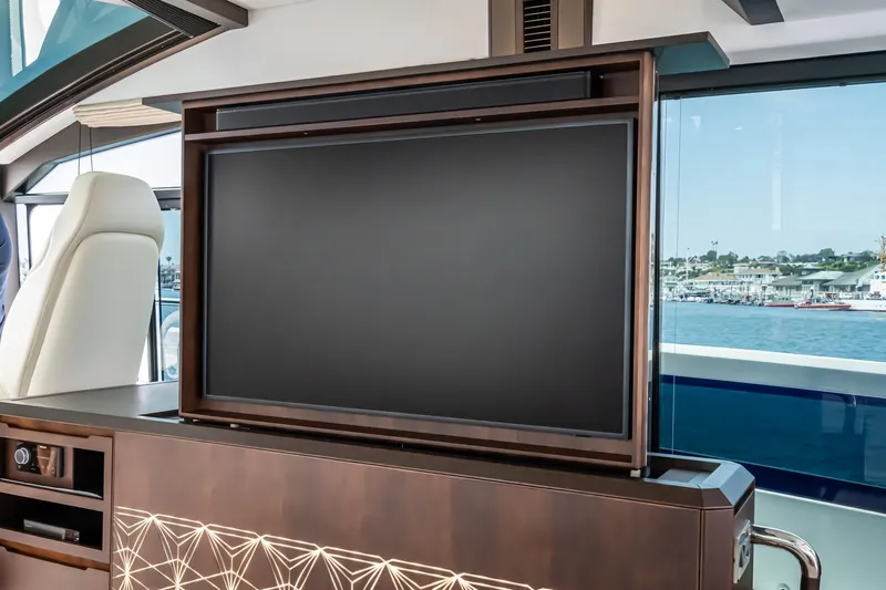  Yacht Photos Pics Luxurious interior of 2023 Galeon 640 Fly yacht with retractable TV and scenic ocean view.