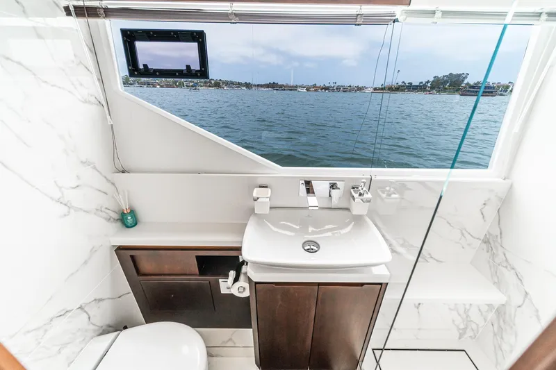  Yacht Photos Pics Luxurious bathroom on 2023 Galeon 640 Fly yacht with ocean view through large window.