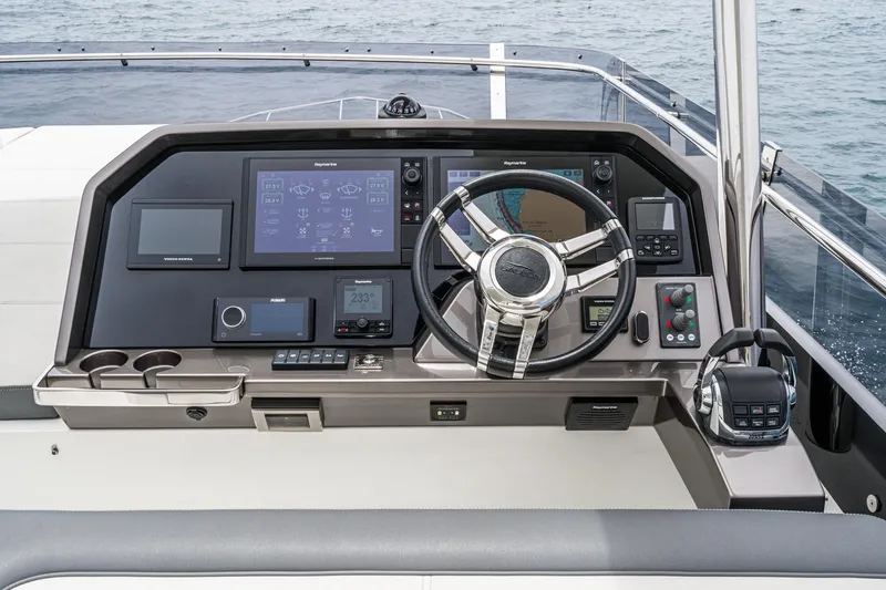  Yacht Photos Pics 2023 Galeon 640 Fly yacht helm with advanced navigation controls and sleek steering wheel.