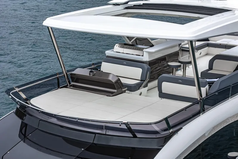  Yacht Photos Pics 2023 Galeon 640 Fly yacht with spacious deck and modern seating on the water.