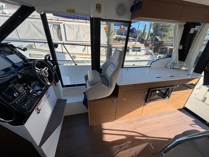  Yacht Photos Pics Interior of 2023 Jeanneau NC 1095 Fly with helm and kitchenette.