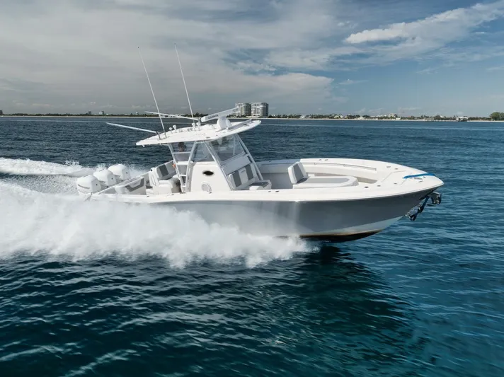 T/t No Shortcuts Yacht Photos Pics 2020 Invincible Open Fisherman boat cruising on clear blue ocean waters.