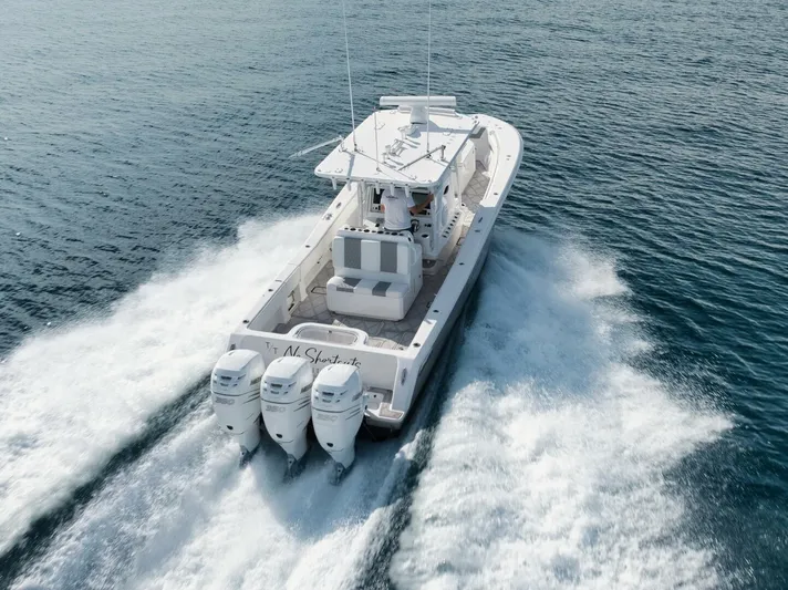 T/t No Shortcuts Yacht Photos Pics 2020 Invincible Open Fisherman boat cruising on open water with triple outboard engines.