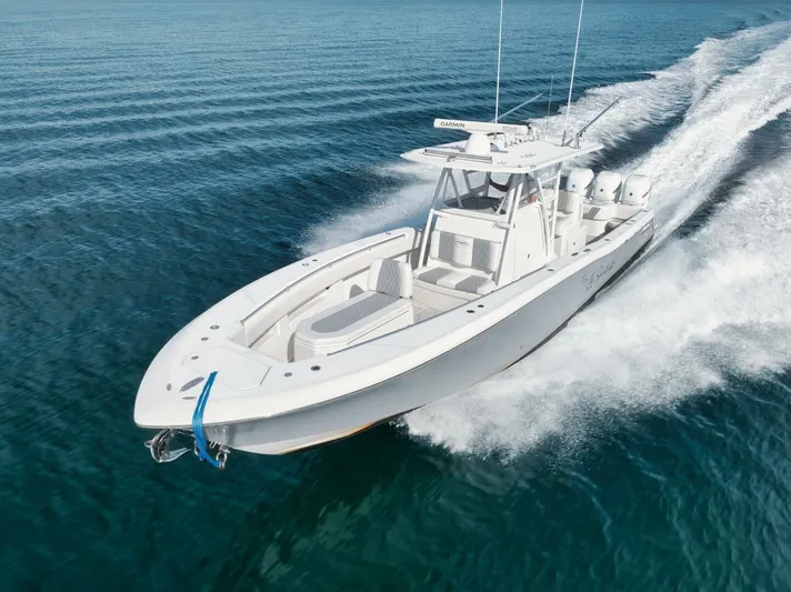 T/t No Shortcuts Yacht Photos Pics 2020 Invincible Open Fisherman boat cruising on clear blue water.