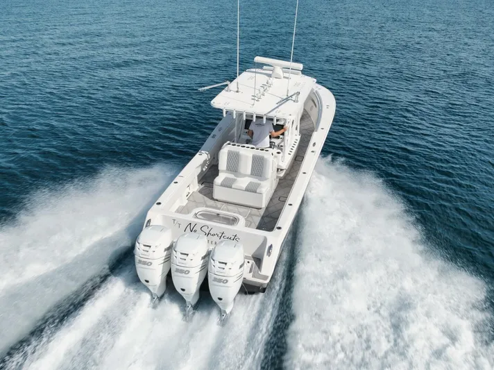 T/t No Shortcuts Yacht Photos Pics 2020 Invincible Open Fisherman boat cruising on open water with triple engines.