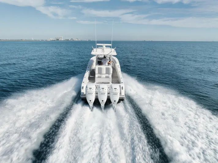 T/t No Shortcuts Yacht Photos Pics 2020 Invincible Open Fisherman boat speeding on open water, leaving a wake behind.