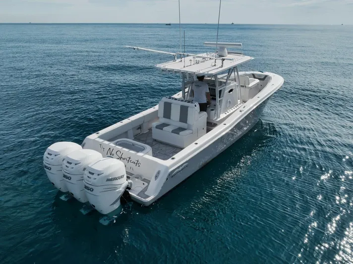 T/t No Shortcuts Yacht Photos Pics 2020 Invincible Open Fisherman boat on calm ocean waters.