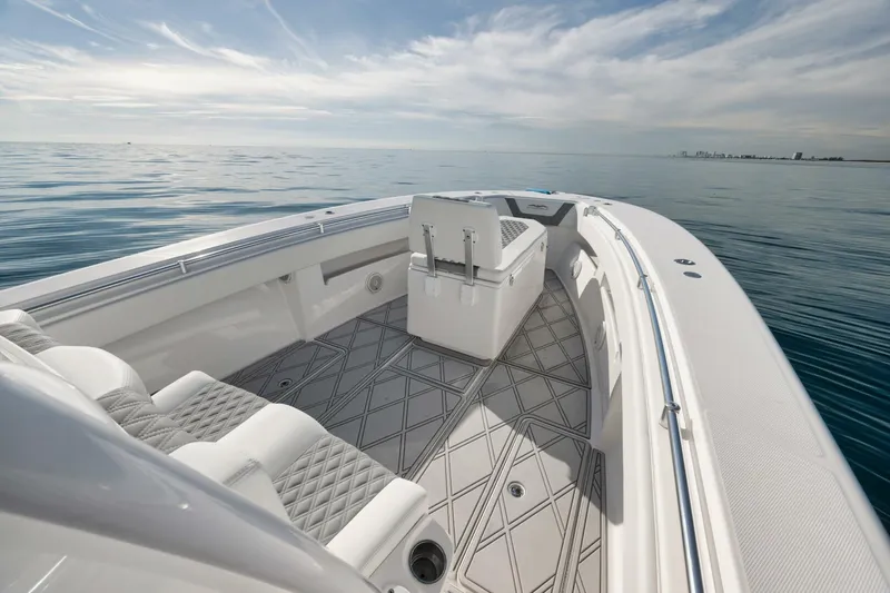 T/t No Shortcuts Yacht Photos Pics 2020 Invincible Open Fisherman boat on calm ocean waters under a clear sky.
