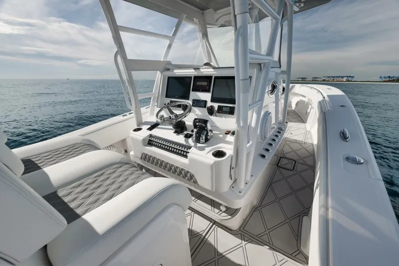 T/t No Shortcuts Yacht Photos Pics 2020 Invincible Open Fisherman boat interior with modern controls and seating on the ocean.