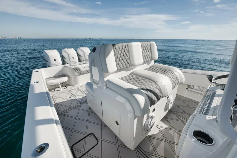 T/t No Shortcuts Yacht Photos Pics 2020 Invincible Open Fisherman boat interior with cushioned seating and ocean view.