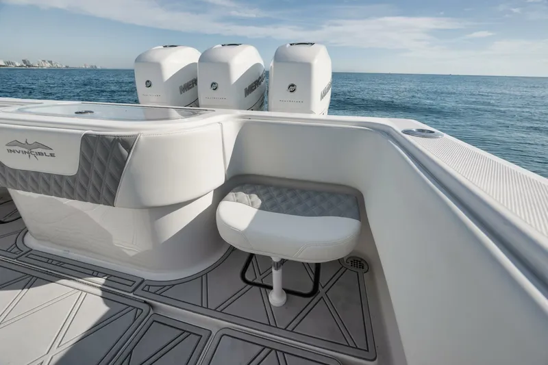 T/t No Shortcuts Yacht Photos Pics 2020 Invincible Open Fisherman boat with triple engines on calm ocean waters.