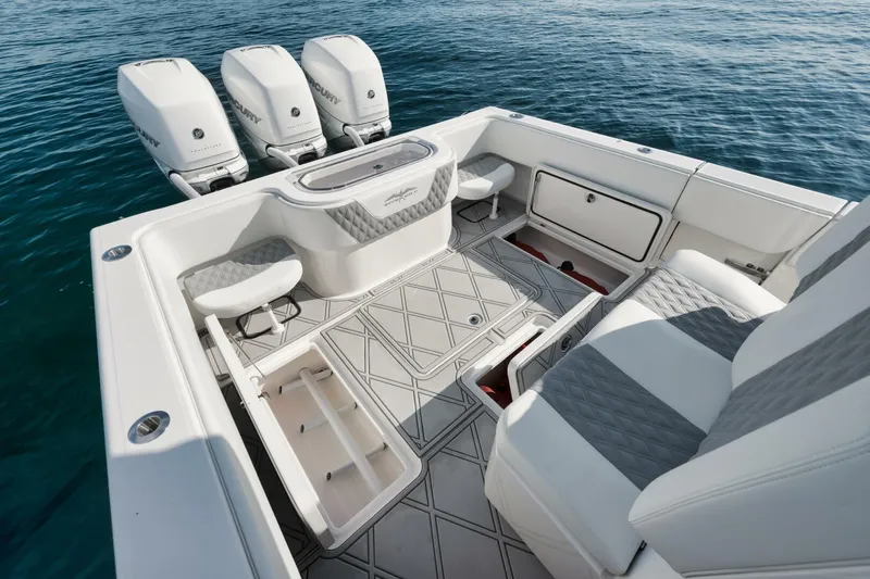 T/t No Shortcuts Yacht Photos Pics 2020 Invincible Open Fisherman boat interior with triple engines, spacious seating, and storage compartments.