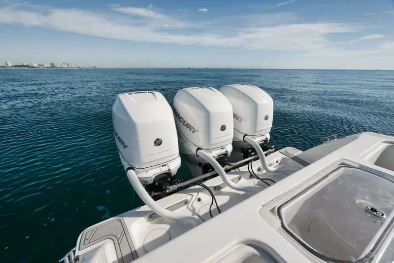 T/t No Shortcuts Yacht Photos Pics 2020 Invincible Open Fisherman boat with triple Mercury outboard engines on open sea.