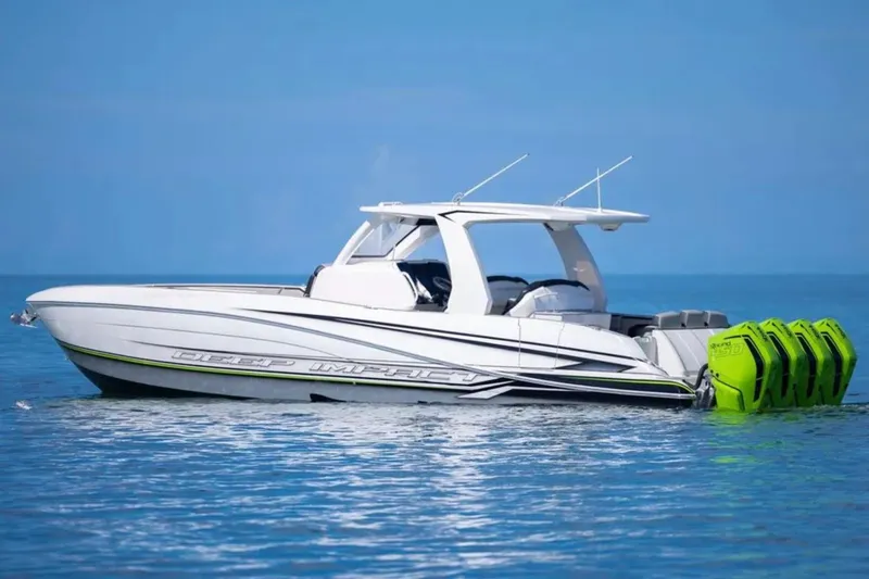  Yacht Photos Pics 2026 Deep Impact 399 Sport boat with vibrant green engines on calm blue water.