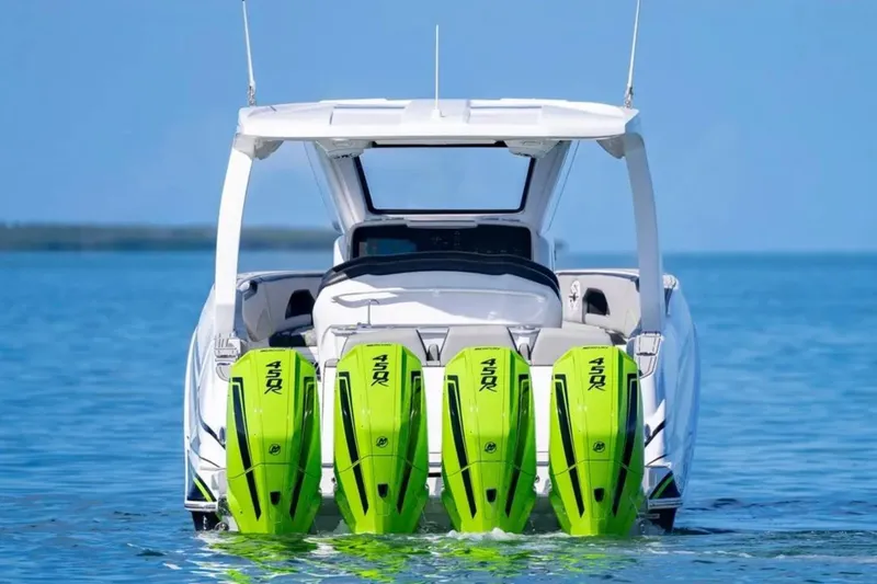  Yacht Photos Pics 2026 Deep Impact 399 Sport boat with four vibrant green outboard motors on water.