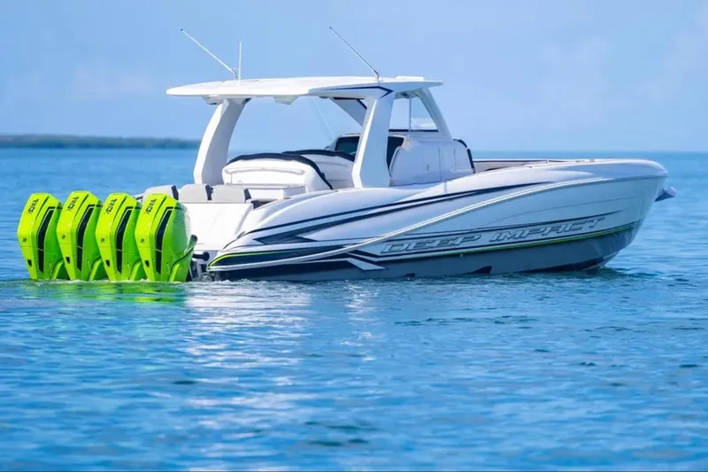  Yacht Photos Pics 2026 Deep Impact 399 Sport boat with four green outboard motors on calm water.