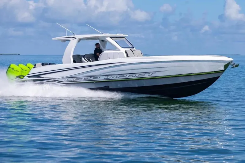  Yacht Photos Pics 2026 Deep Impact 399 Sport boat cruising on clear blue water.